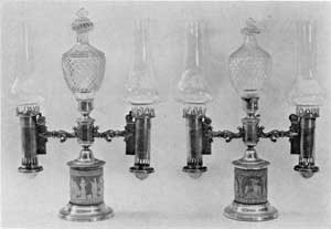 English Regency Period Lamps: The lighting fuel used in such lamps equipped with Argand burners was generally a refined sperm oil. This pair have Wedgwood jasper-ware bases, elaborate Waterford cut-glass decorative finials, and carefully blown glass chimneys so shaped as to make them the best source of artificial lighting possible.