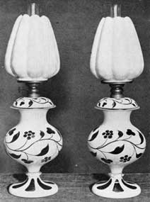 Handsome Sandwich Lamps: Made with opaque white and rose-colored overlay glass bases and shades of a delicate pink glass with translucent white on the outside. Lamps such as these date from the time when kerosene had replaced other fuels for lighting purposes.