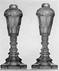 Sandwich Glass Lamps: Of cobalt-blue pressed glass, these originally had burners with double-wick tubes that screwed into the metal collar at the top of the font. They were used first for whale oil and later for the more improved types of illuminants